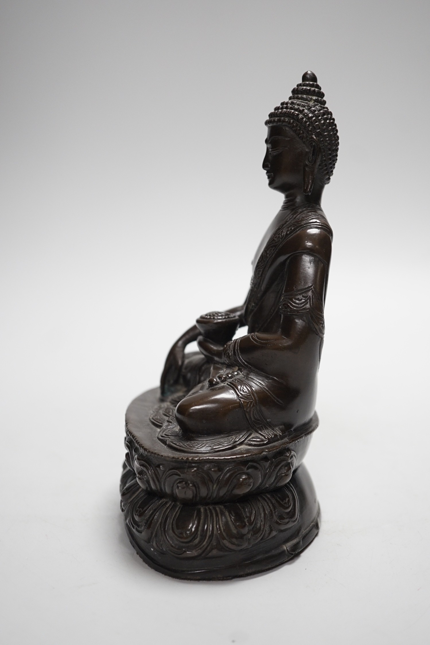 A Chinese bronze Buddha, on lotus base, 20cms high
